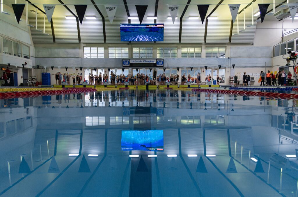 Pool-level view of swimmers waiting before warm-up
